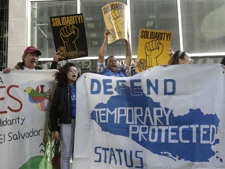 Supporters of temporary protected status immigrants hold signs and cheer at a rally outside a federal courthouse in San Francisco, Monday, March 12, 2018. 